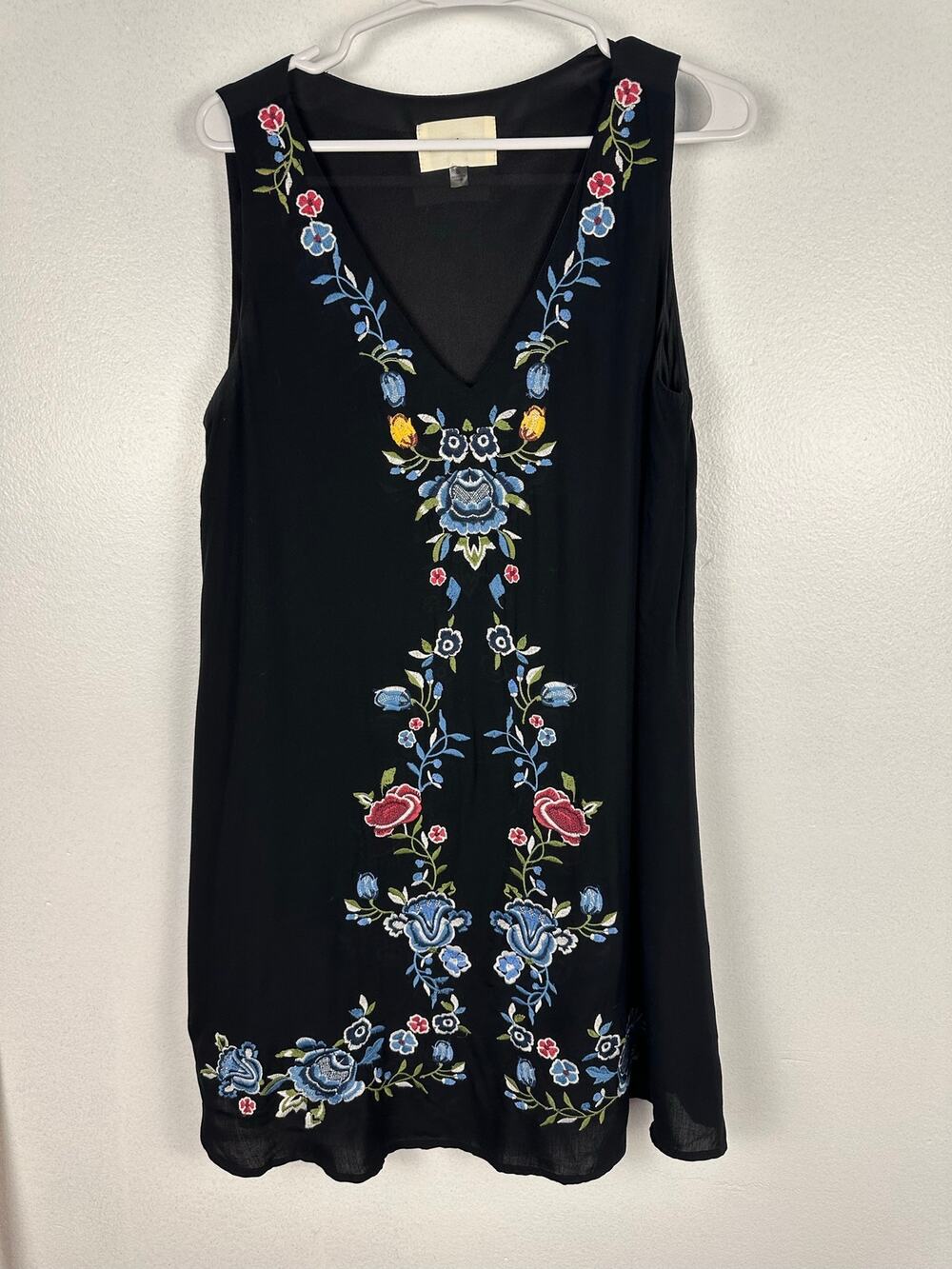 The Cove black boho dress features heavy floral embroidery and v-neckline small